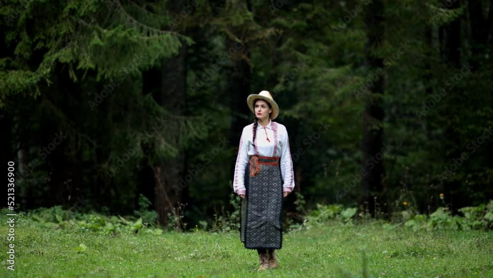 Romanian girl walks through a forest clearing Romanian girl walks through a forest clearing