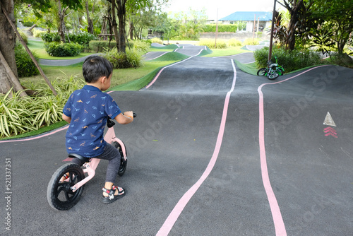 A Boy riding his bicycle on a pump track, Bike Park, Thailand