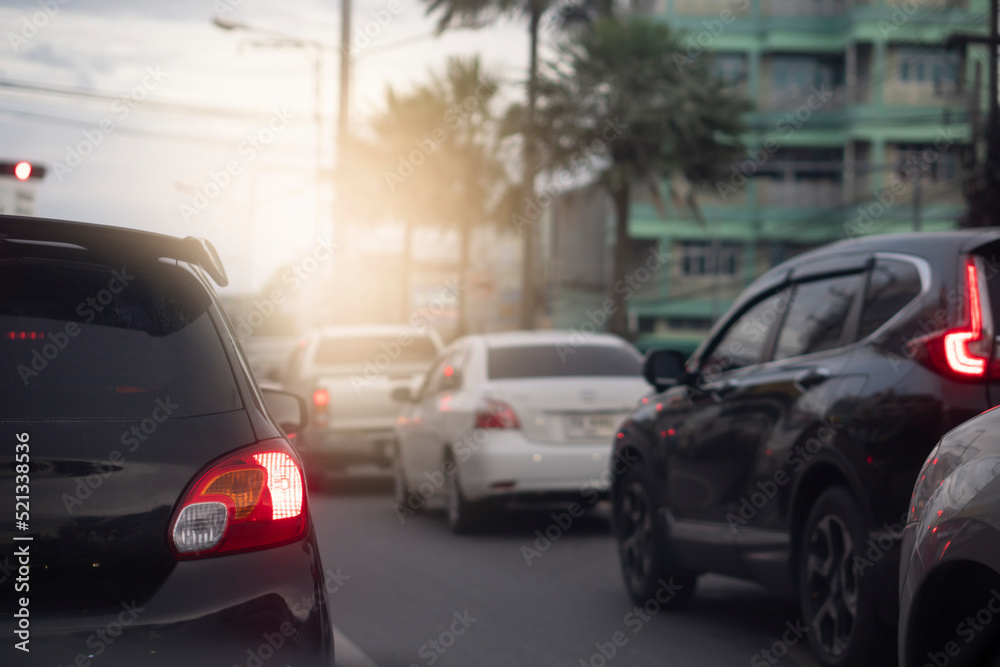 Traffic on the roads in the provinces in the evening. Abstract and blurred of rear side of black car with turn on brake light. 