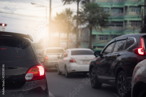 Traffic on the roads in the provinces in the evening. Abstract and blurred of rear side of black car with turn on brake light.  © thongchainak