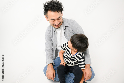 Portrait of a parent and child looking at each other. 2 people.