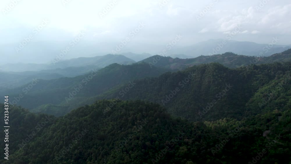 Drone shot flying over beautiful mountain ridge and clouds in rural jungle bush forest .Tree tops against sunny sky. Drone shot flying over beautiful mountain ridge and clouds in rural jungle bush forest .Tree tops against sunny sky.