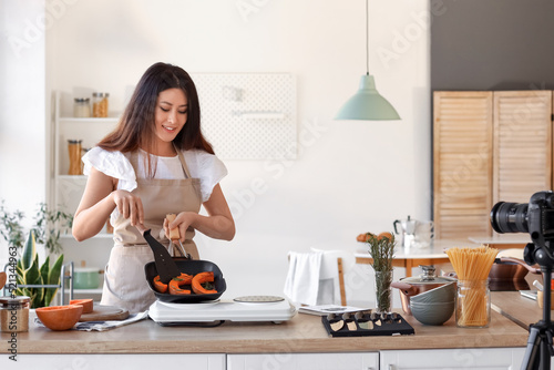 Young Asian woman frying pu...