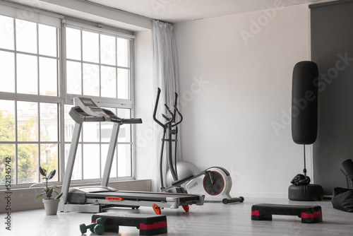Fotografía Interior of modern gym with treadmill and sport equipment