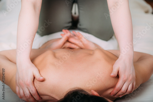 Back massage in a massage salon, woman having a relaxing back massage.