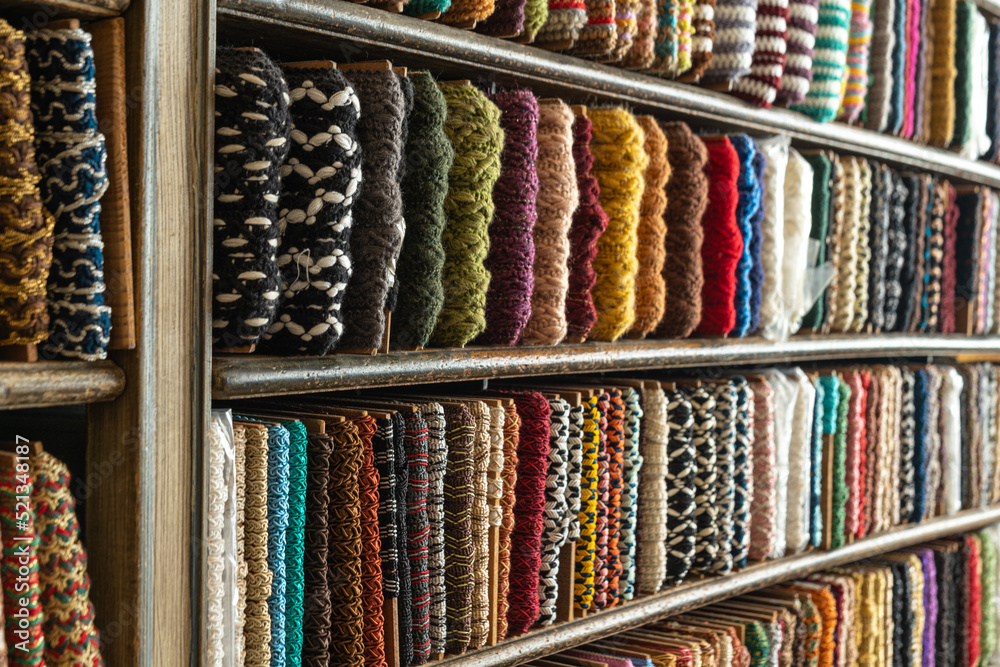 multi-colored bright golden braid located on the counter of the store for decoration, sewing and needlework. Textile background