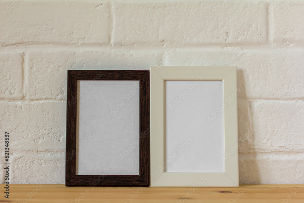 Fototapeta premium Empty photo frames on the table with copy space.