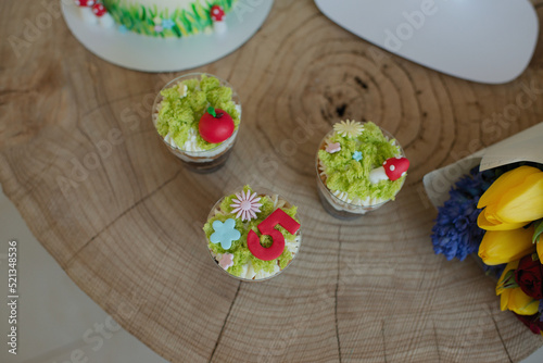 Baking cakes and cupcakes decorated in forest style, grass, mushrooms and a little princess