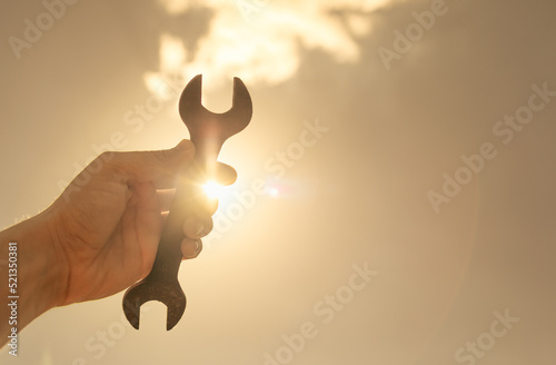 Hand holding a wrench tool. Do it yourself, fix, repair, build concept. 