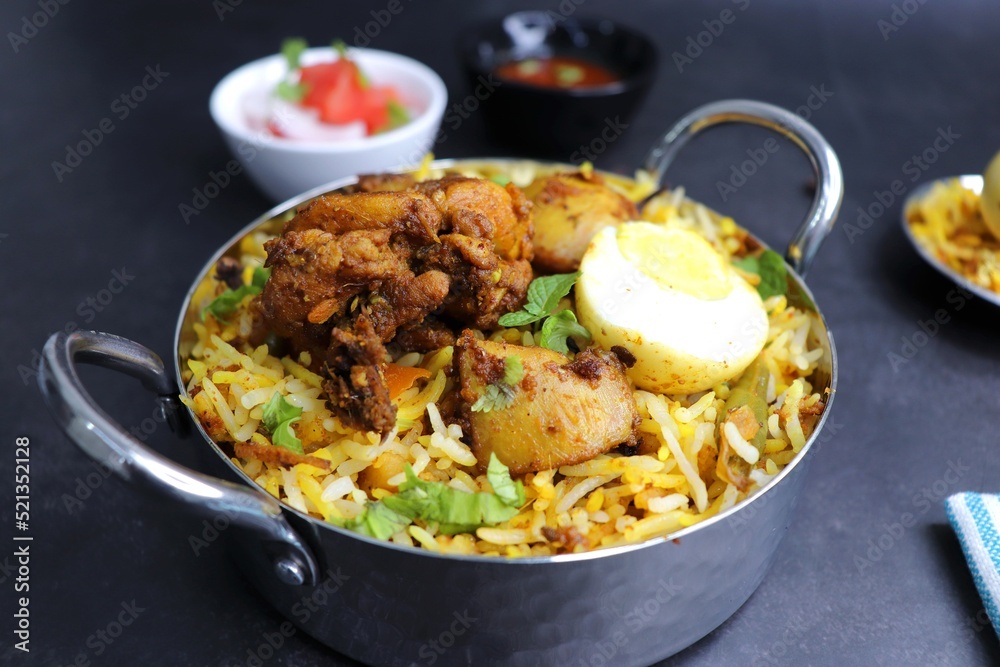 Chicken Biryani or murgh Pulao. Garnished with fried onion, mint leaves, and Boiled egg. Biryani is a famous Spicy nonvegetarian dish of India. Chicken cooked along with Basmati rice. Cucumber Raita. Chicken Biryani or murgh Pulao. Garnished with fried onion, mint leaves, and Boiled egg. Biryani is a famous Spicy nonvegetarian dish of India. Chicken cooked along with Basmati rice. Cucumber Raita.