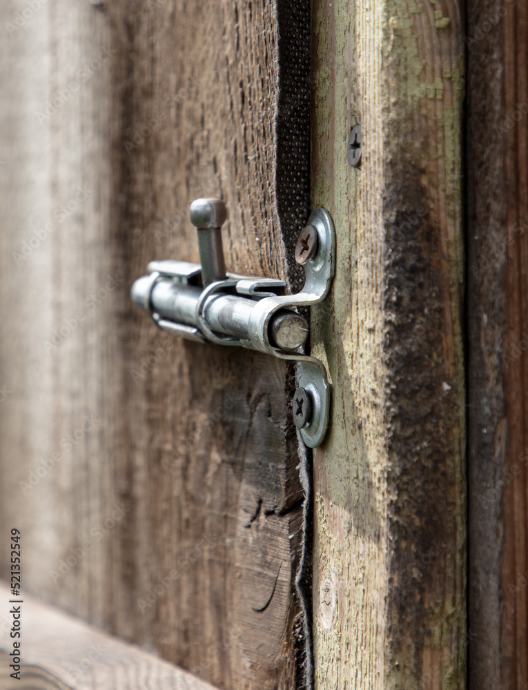 A latch on an old wooden door. A latch on an old wooden door.