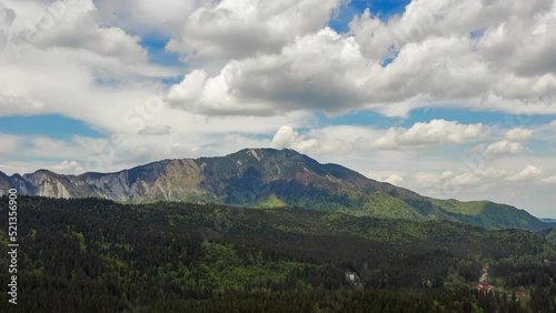 Aerial hyperlapse pushing in towards Postavarul Massif in Romanian Carpathians photo