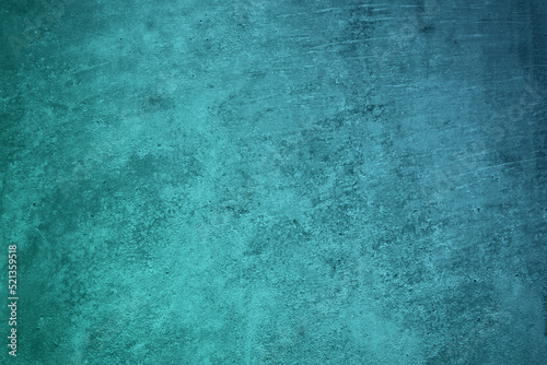Dark blue green wall texture. Gradient. Teal color. Toned old rough concrete surface. Close-up. Abstract vintage background with space for design. Web banner.