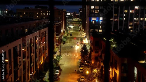 push in shot from inside of a condo outside looking down a city street at night