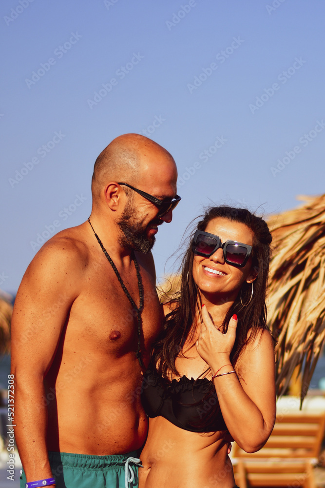 Fototapeta premium Beautiful Happy Couple hugging and kissing enjoying Vacation holidays a near the beach