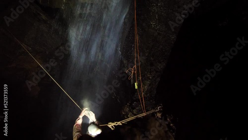 Tyrolean traverse over a waterfall in a cave in Tasmania photo