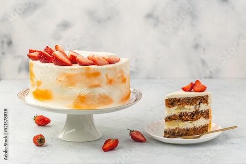 Strawberry cake, strawberry sponge cake with fresh strawberries and sour cream on a white background.
