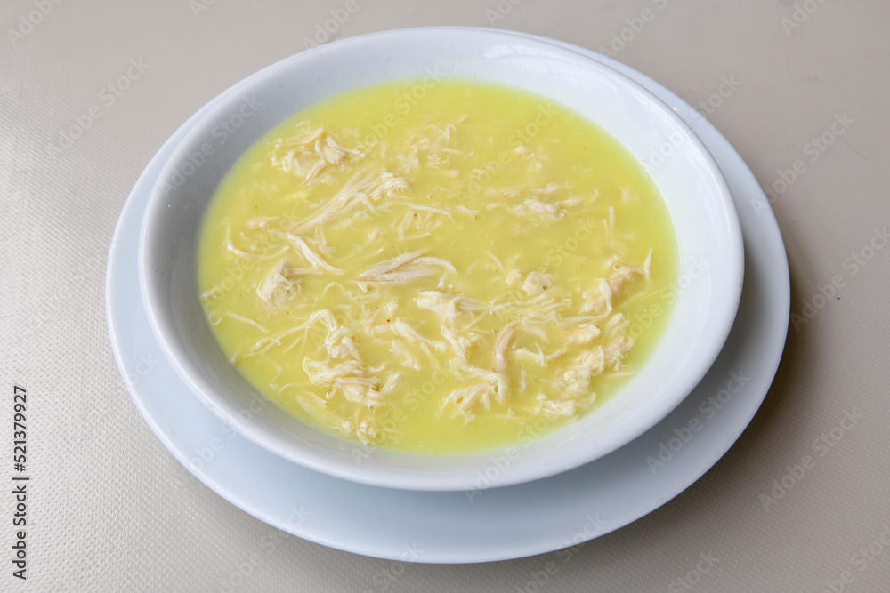 Homemade turkish soup Tavuk Suyu corbasi in a white ceramic soup plate.Turkish noodle chicken broth soup on a plate. Turkish meal (sehriyeli tavuk suyu corbasi) Homemade turkish soup Tavuk Suyu corbasi in a white ceramic soup plate.Turkish noodle chicken broth soup on a plate. Turkish meal (sehriyeli tavuk suyu corbasi)