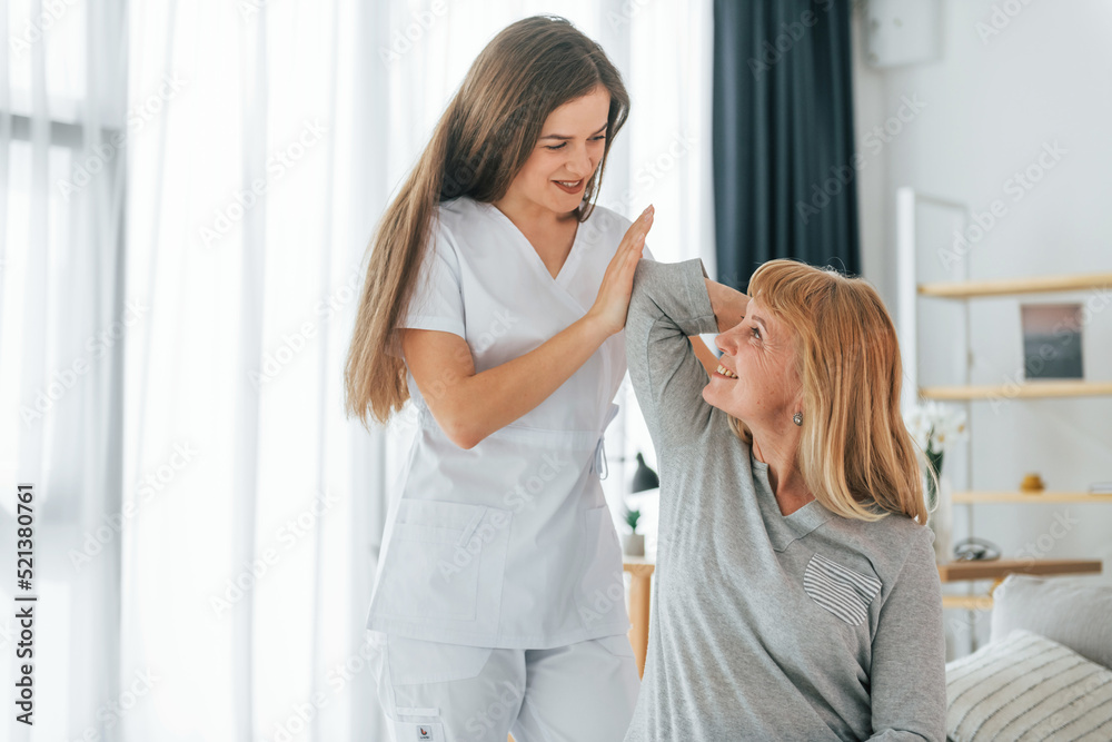 Neck massage. Senior woman is visiting physician in the office Neck massage. Senior woman is visiting physician in the office