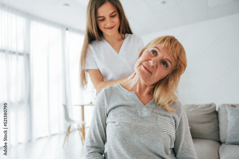 Fototapeta premium Neck massage. Senior woman is visiting physician in the office