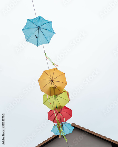 colorful umbrellas in the city against the sky