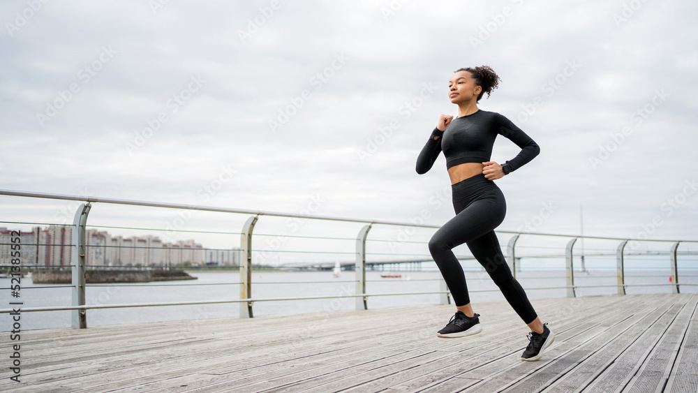 A runner woman is engaged in fitness running in comfortable sportswear, a smart watch on her hand