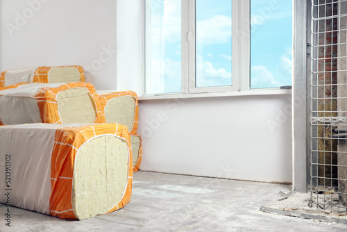 Obraz na plátně Packages of thermal insulation material in room. Space for text