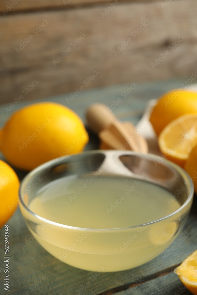 Freshly squeezed lemon juice in glass bowl on table Freshly squeezed lemon juice in glass bowl on table