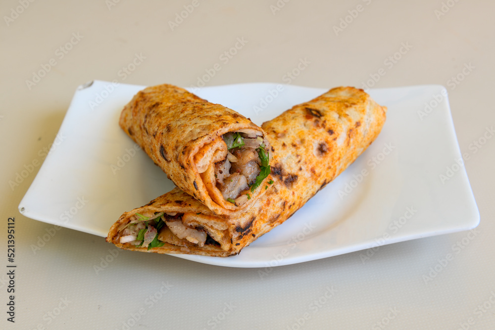 Lavash doner kebab ( doner zurna durum ) or shawarma sliced in plate isolated. Lavash doner kebab ( doner zurna durum ) or shawarma sliced in plate isolated.