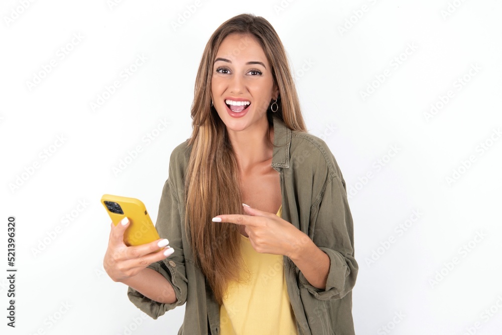 Portrait cute astonished young beautiful woman wearing green overshirt over white background impressed unbelievable unexpected incredible notification advice Portrait cute astonished young beautiful woman wearing green overshirt over white background impressed unbelievable unexpected incredible notification advice