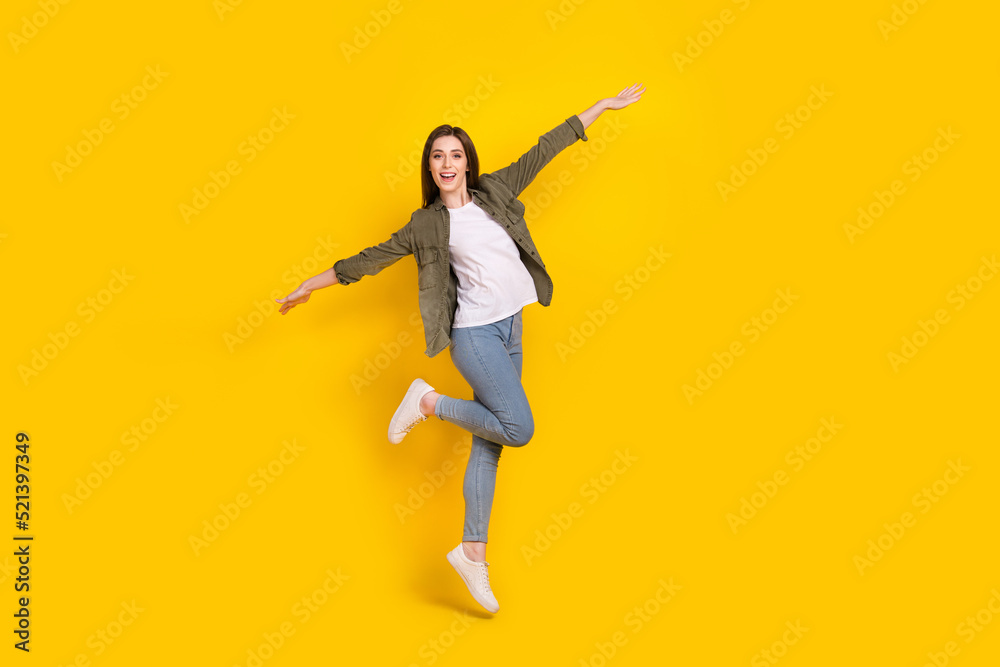 Full body photo of cheerful lady tourist have fun during summer travel around the world isolated on yellow color background