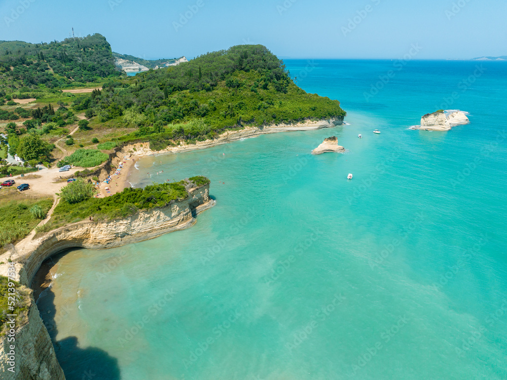 Aerial view of the cliff overlooking the sea near Apotripiti beach and of Mermaid's rock, a promontory on the crystal clear sea. Corfu island, Greece, Ionian sea