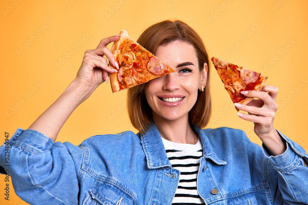 woman covering her eyes with a slice of fresh pizza