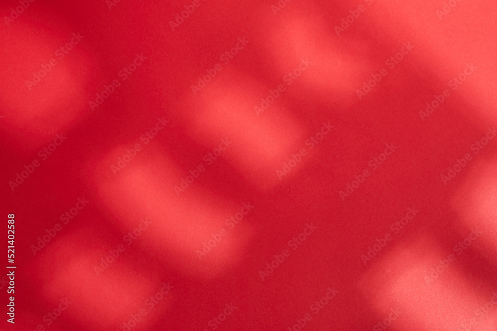 Illuminated light with gobo mask on red  background.