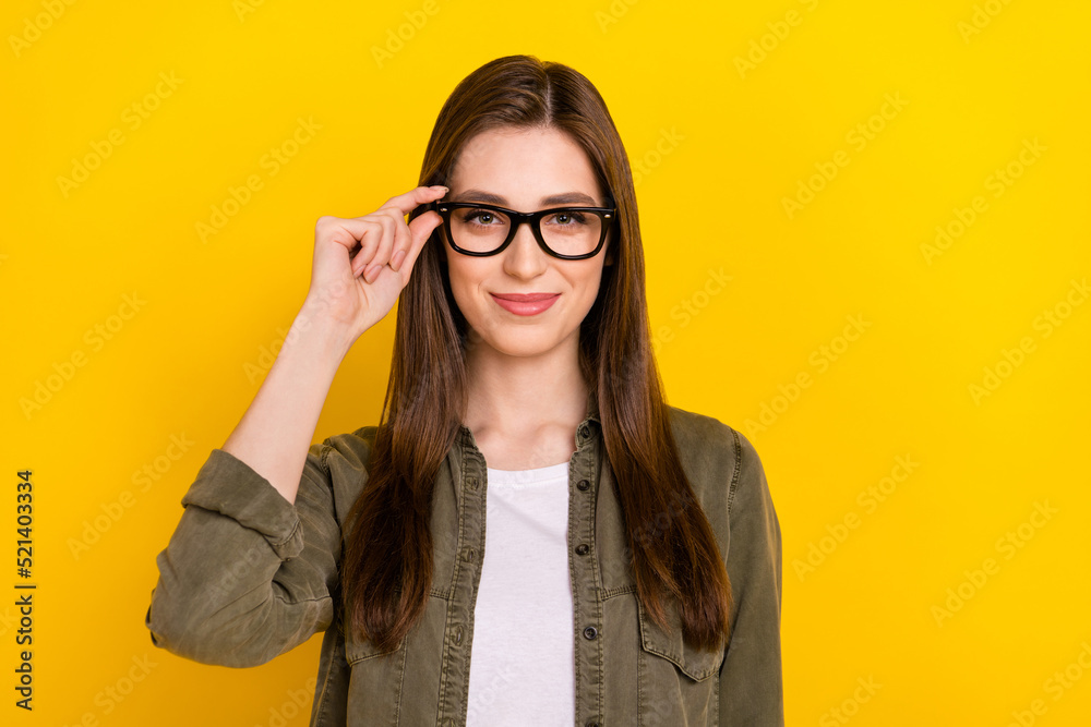 Portrait of good looking female office worker wear spectacles working in leading it company isolated on yellow color background