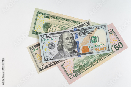 5, 20, 50, 100 dollars banknotes at different angles. Close up of dollars on white background.