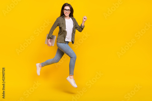 Full body photo of good mood energetic young business lady running to work isolated on yellow color background