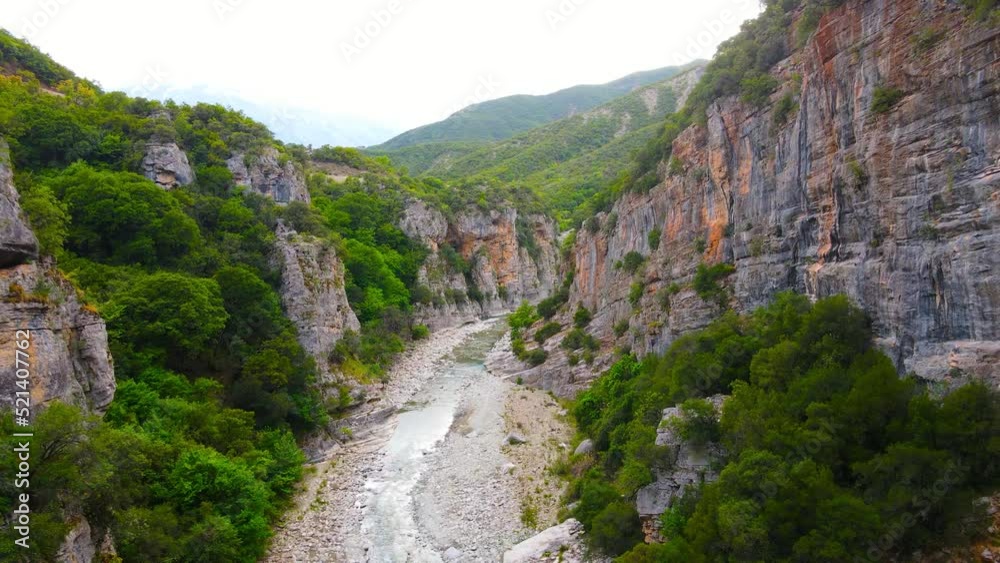 Top-down drone shot of Lengarica Canyon. An extremely narrow Lengarica gorge, behind the thermal springs of Benja, Fir of Hotova National Park, southern Albania. Beautiful cinematic aerial shot. Top-down drone shot of Lengarica Canyon. An extremely narrow Lengarica gorge, behind the thermal springs of Benja, Fir of Hotova National Park, southern Albania. Beautiful cinematic aerial shot.