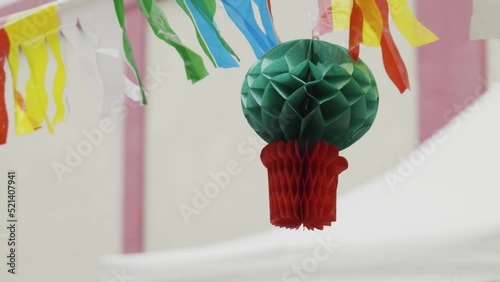 Colorful flags and figures blowing in the wind - they are used for decoration at the São João and Santos Populares in Lisbon and Porto, Portugal. This one is called Manjerico (Ocimum minimum). photo