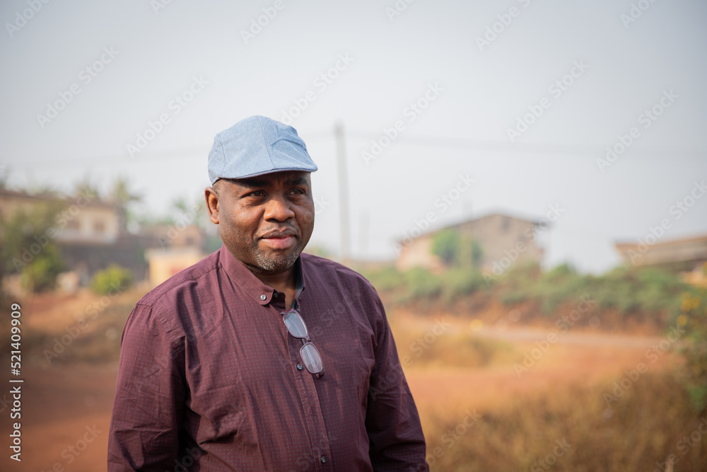 Portrait of a happy mature African gentleman wearing a flat cap outdoors. Portrait of a happy mature African gentleman wearing a flat cap outdoors.