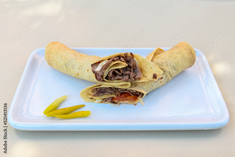 Lavash doner kebab ( doner zurna durum ) or shawarma sliced in plate