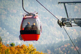 Gondola Lift with elderly pair on Jaworzyna Krynicka Mountain in autumn. Krynica-Zdroj, Poland.