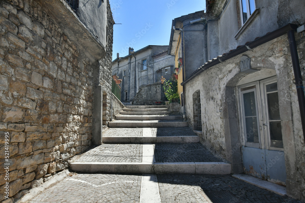 A narrow street among the old houses of Greci, a village in the Campania region, Italy.