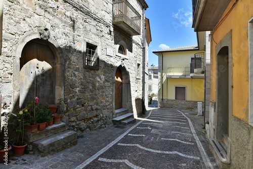 A narrow street among the old houses of Greci, a village in the Campania region, Italy. © Giambattista