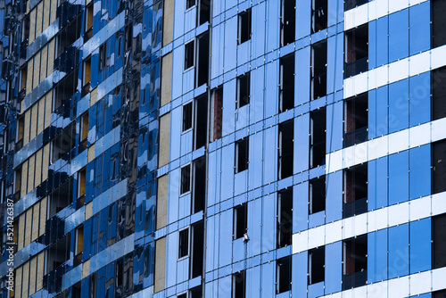 Facing the building with a ventilated facade. Aluminum colored facades. Modern facades of high-rise buildings. Construction of a large residential complex photo