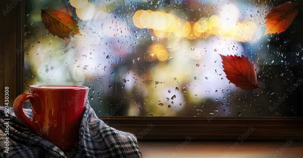 A cup of hot autumn coffee or tea on the window. Living in Hygge style. Hot drink in cold autumn weather - obrazy, fototapety, plakaty 