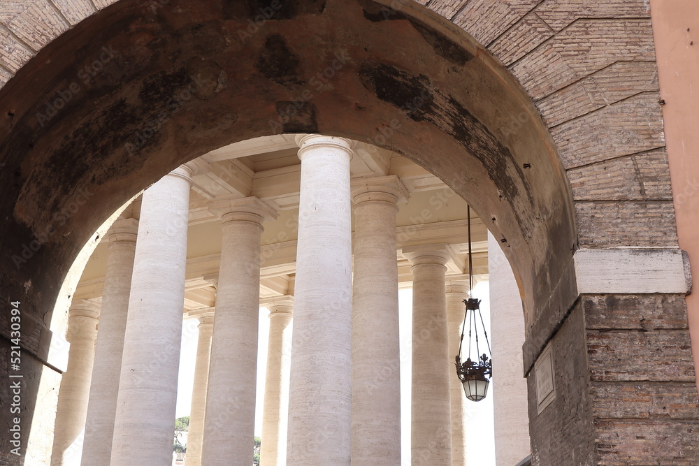 St. Peter's Colonnade Detail Framed by an Arch in Rome, Italy