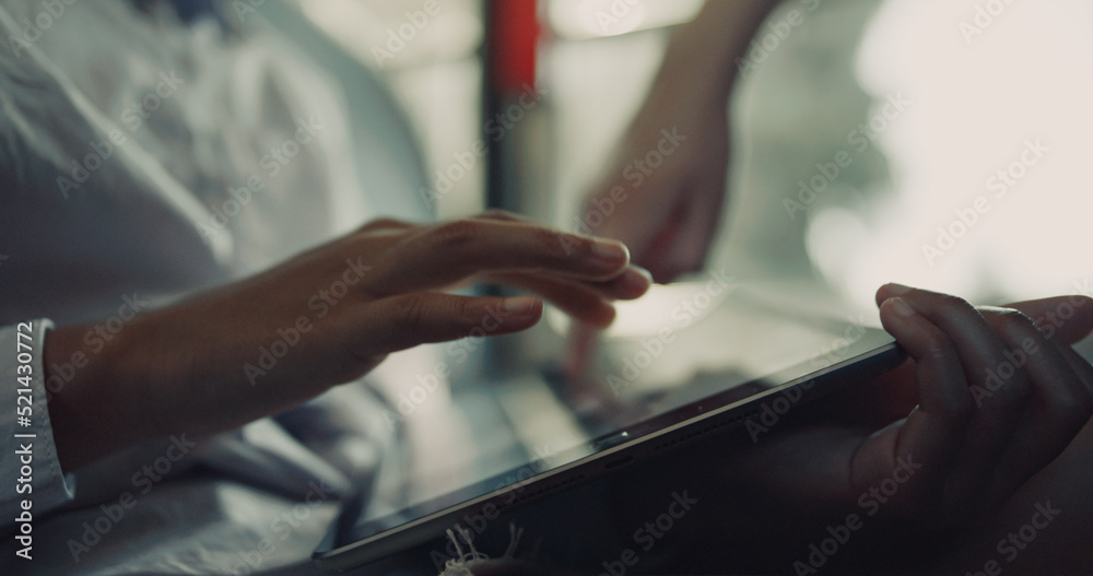 Pupils hands tapping tablet close up. Unrecognized children enjoy online games. Pupils hands tapping tablet close up. Unrecognized children enjoy online games.