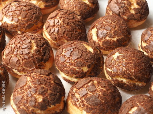 Choux pastry with chocolate craquelin photo
