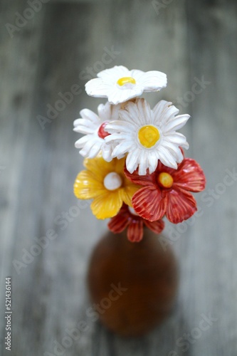 Ceramic spring flowers in a wooden vase